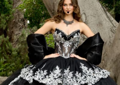 Black quinceañera ball gown with white floral appliqué at Hem & Her Bridal in Tucson, AZ